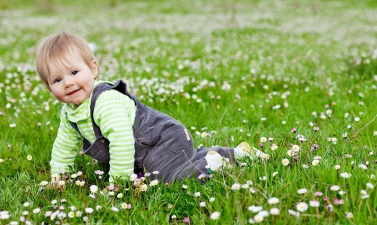 Baby Playing On Grass