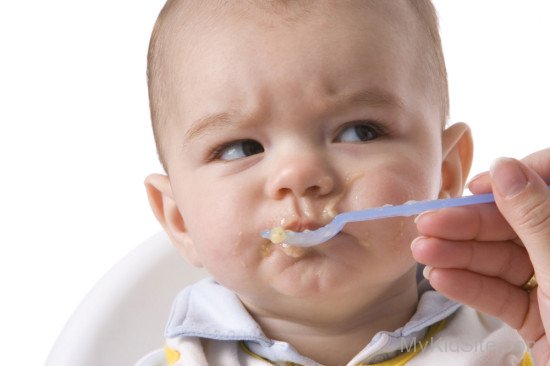 Small Baby Taking Food With Spoon