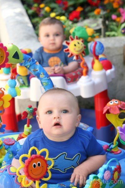 Twin Baby Boys With His Toys