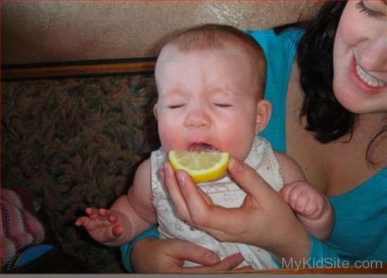 Baby Eating Lemon