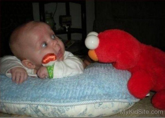 Baby Enjoying With Teddy