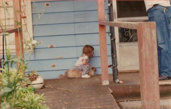 Baby Girl Sitting On Dog