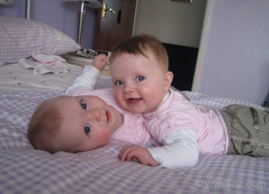 Twin Baby Wearing Pink Dress