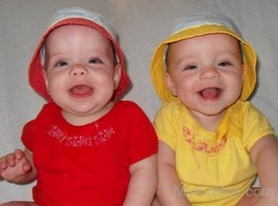 Twin Baby Wearing Red And Yellow Dress