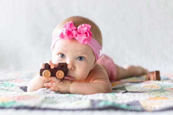 Baby Girl Holding Small Car