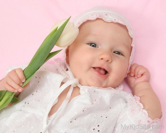 Baby Girl Holding Tulip flower