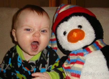 Baby Girl With Toy Penguin