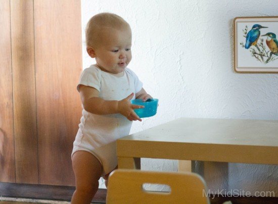 Baby Holding Bowl