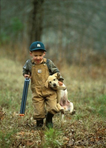 Cute Baby Boy Holding Dog