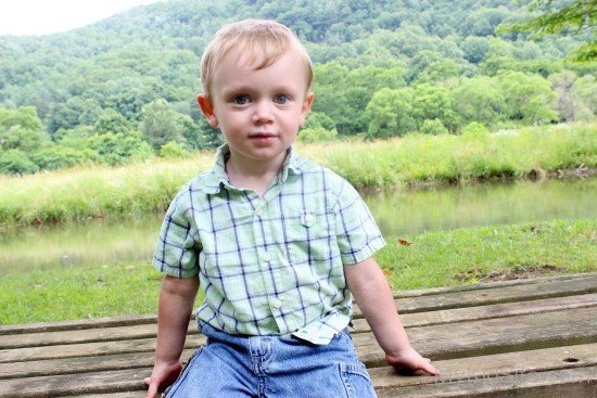 Cute Baby Boy On Wooden Bench