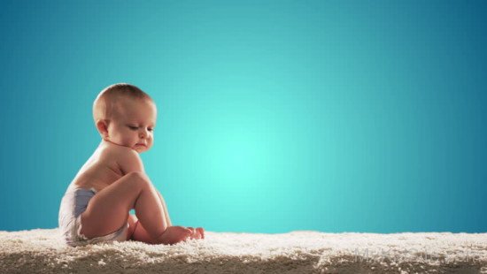 Cute Baby Sitting On Carpet