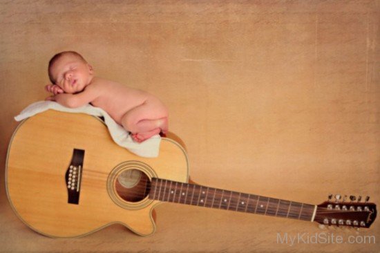 Cute Baby Sleeping On Guitar