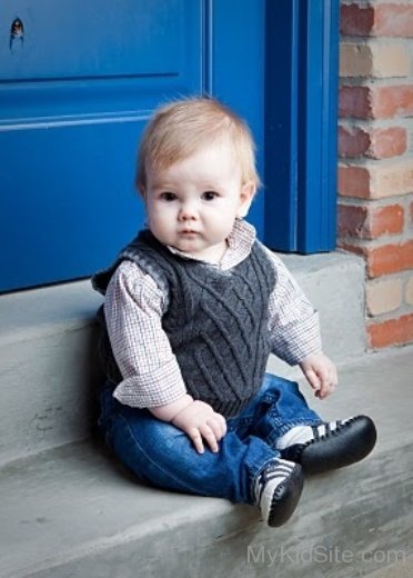 Cute Boy Sitting On Stair