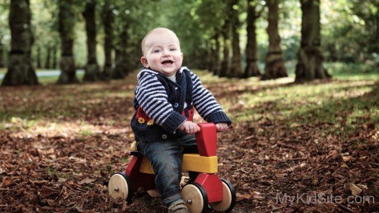 Baby Boy Sitting On Horse