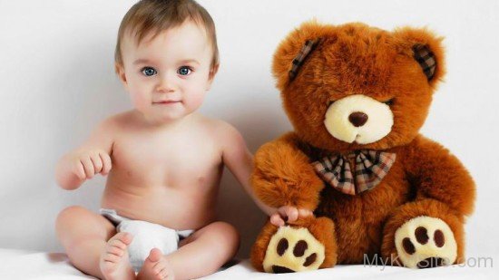 Baby Boy Sitting with Teddy Bear