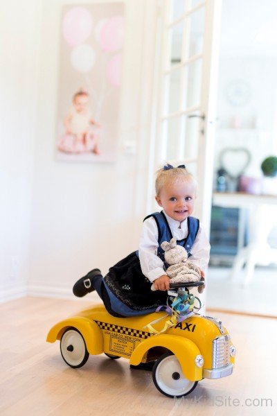 Beautiful Girl On Toy Car