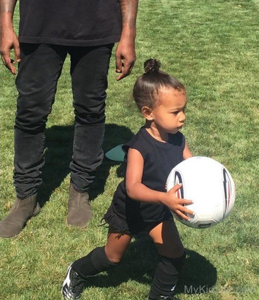 Cute Baby Girl Holding Football