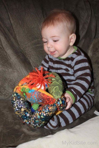 Cute Baby Girl Holding Toy