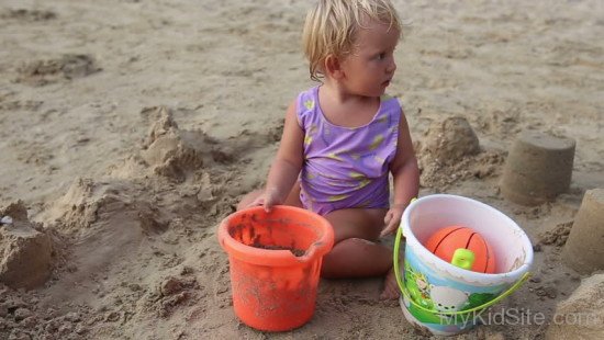 Cute Baby Girl Playing In Mud