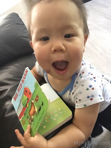 Baby Holding Book