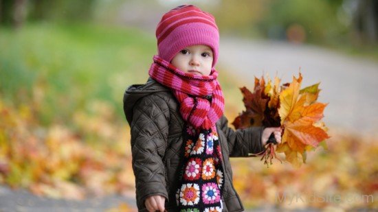 Cute Girl Holding Leaves
