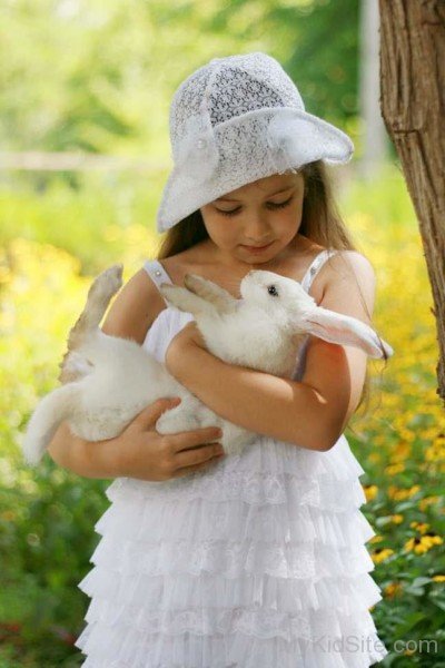 Cute Girl Playing With Rabbit