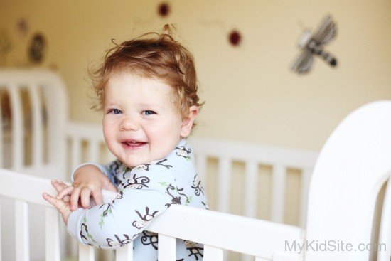 Cute Smiling Baby Boy In Swing