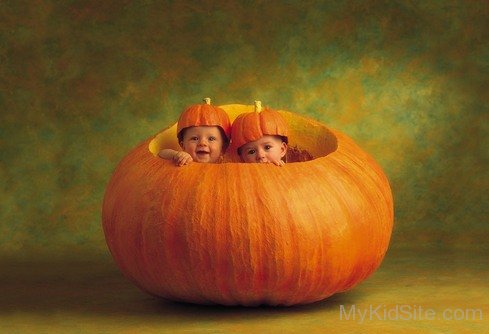 Two Cute Baby In Pumpkin