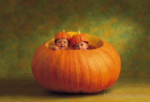 Two Cute Baby In Pumpkin