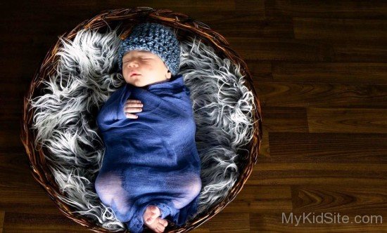 Baby Boy Sleeping In Basket
