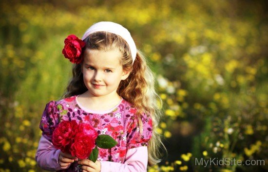 Baby Girl Holding Red Roses