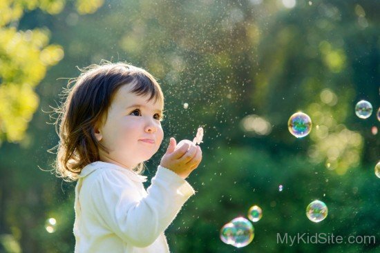 Baby Girl Pllaying With Soap Bubbles