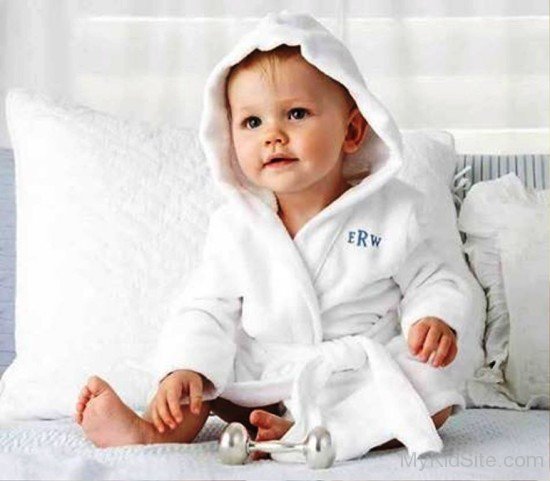 Cute Baby Boy Sit On Bed