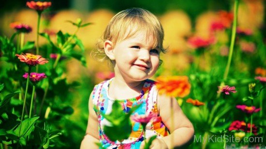 Cute Baby Hirl In Zinnia Flowers