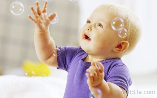 Sweet Baby Girl Playing With Bubbles