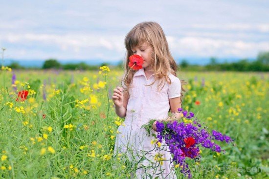 Beautiful Baby Girl Holding Flowers