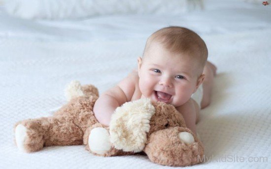 Cute Baby Boy Playing With Teddy