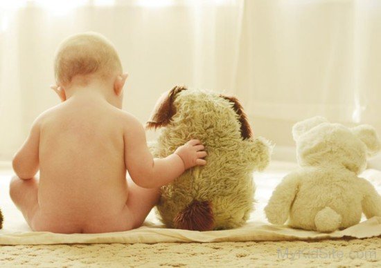 Cute Baby Boy Sitting With Teddy