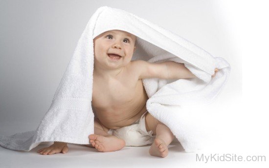 Little baby under white  towel