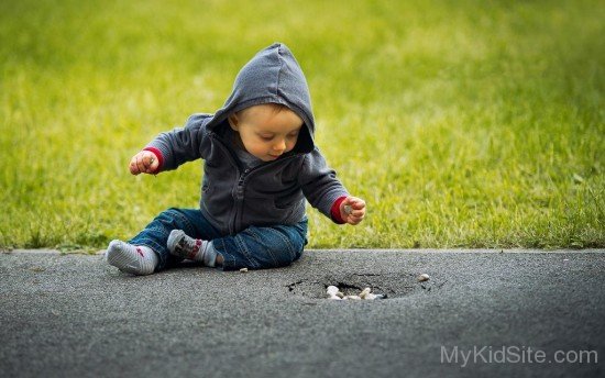 Boy Sitting On Street-cu127