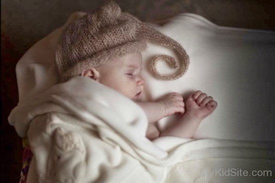 Child Sleeping On Bed