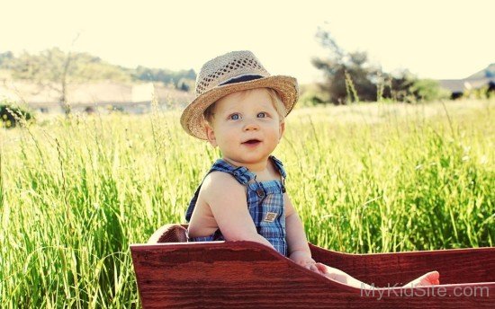 Hat Boy Sitting On Meadow-cu238