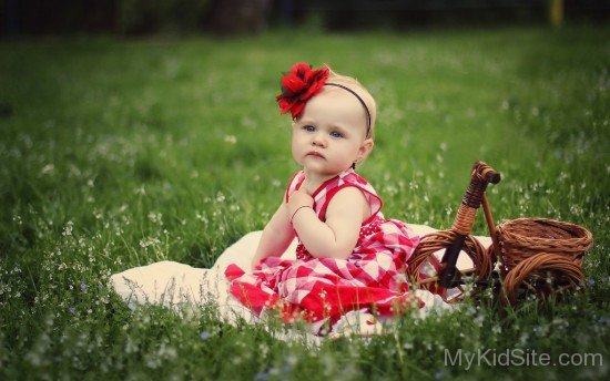 Little Princess Sitting On Grass